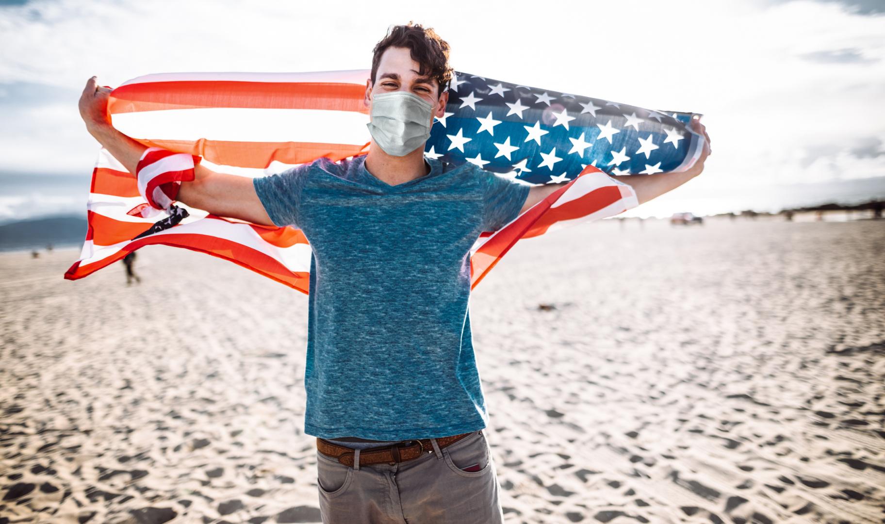 man with mask and U.S. flag
