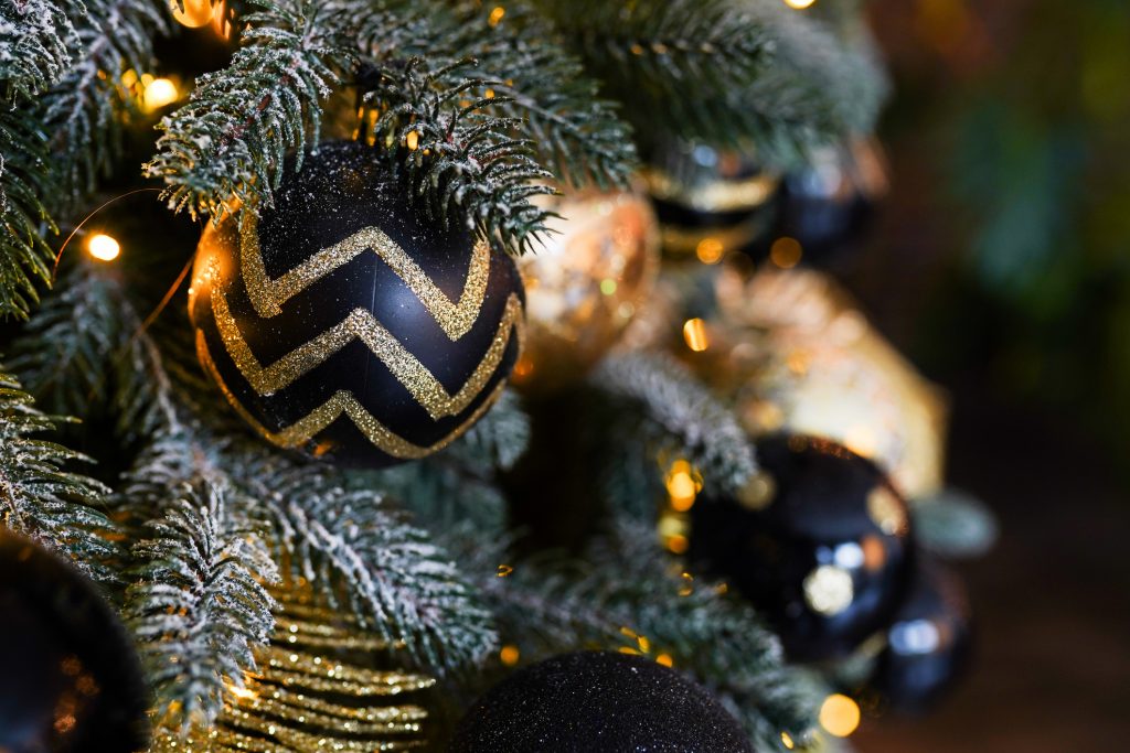 Christmas or New Year decoration background fir-tree branch with golden and black balls