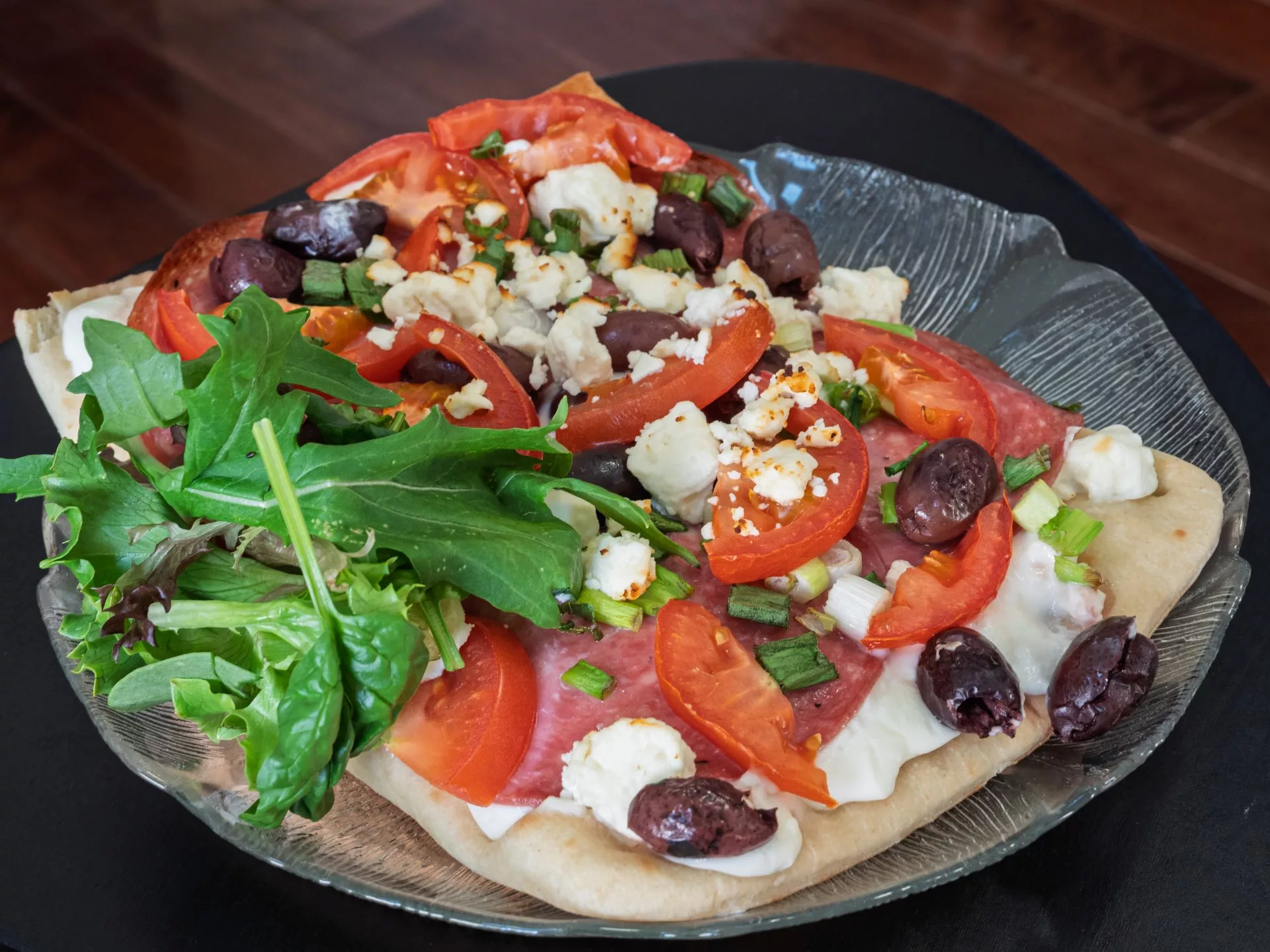 Photo of greek pizza on a plate