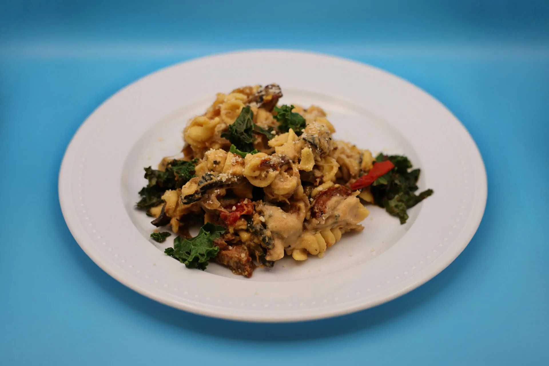 Tomato Zucchini Pasta with Basil Cashew Cream on a white plate