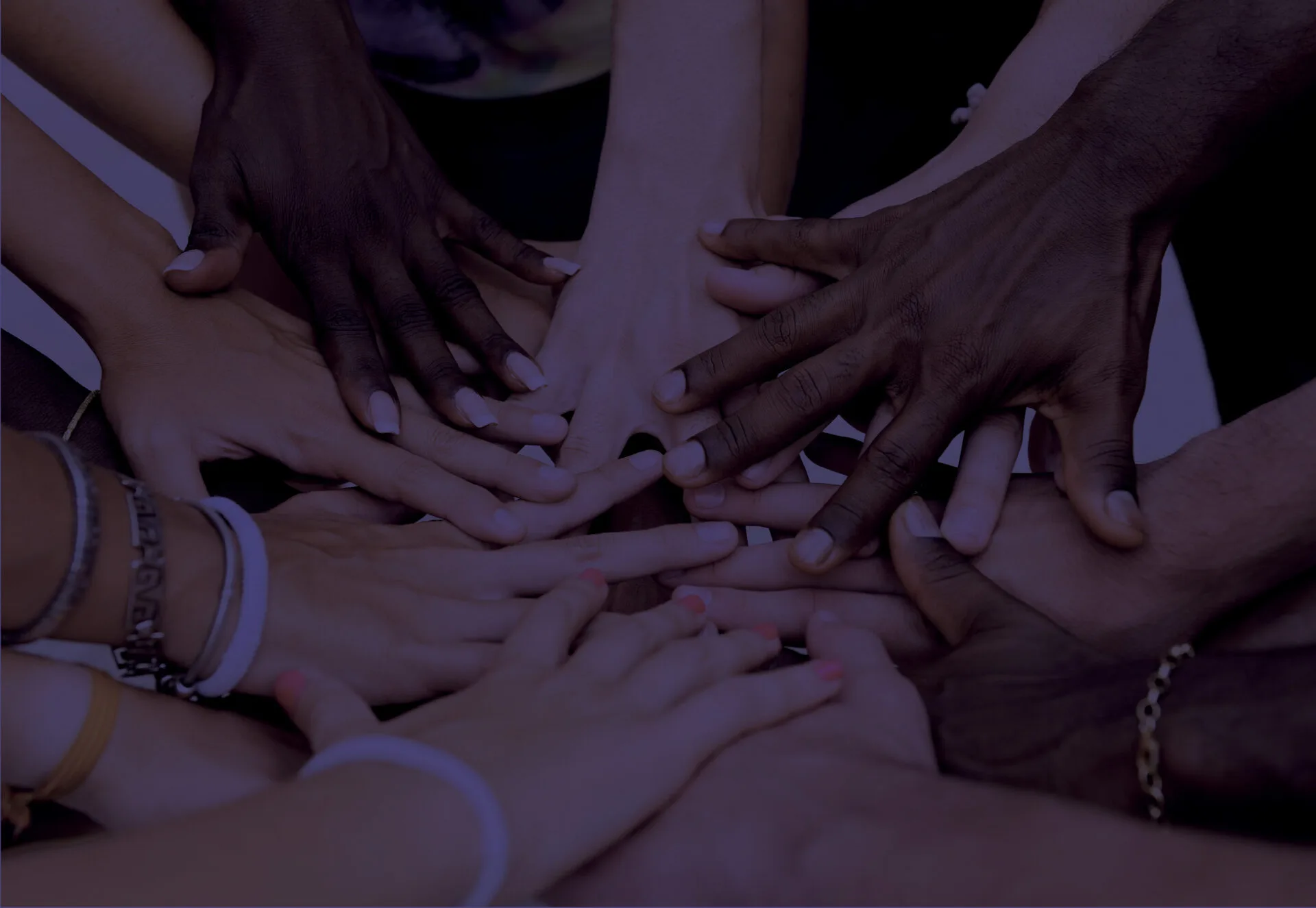 Multicultural hands touching to form a circle
