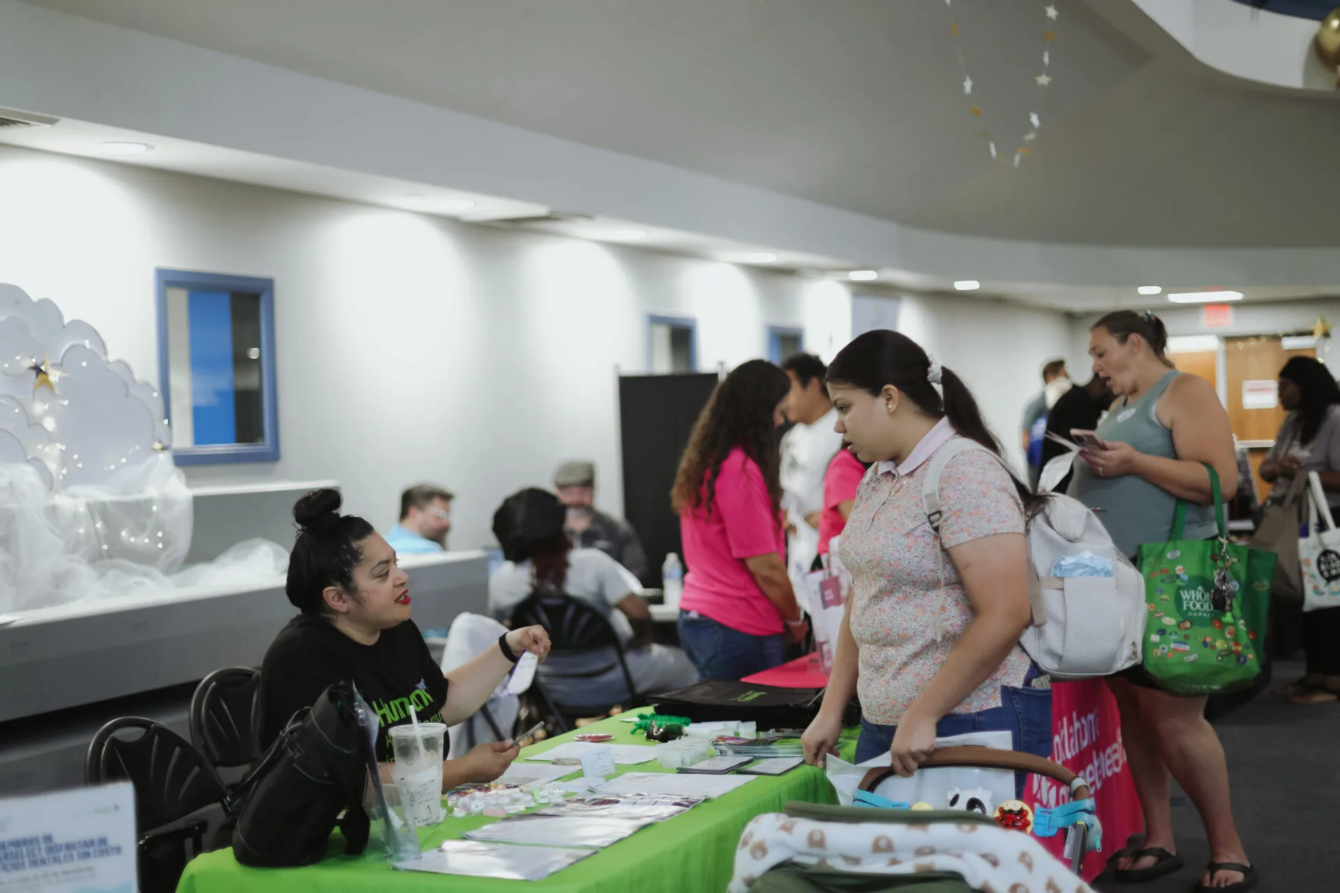 Participants of the Community Baby Shower talking to a vendor