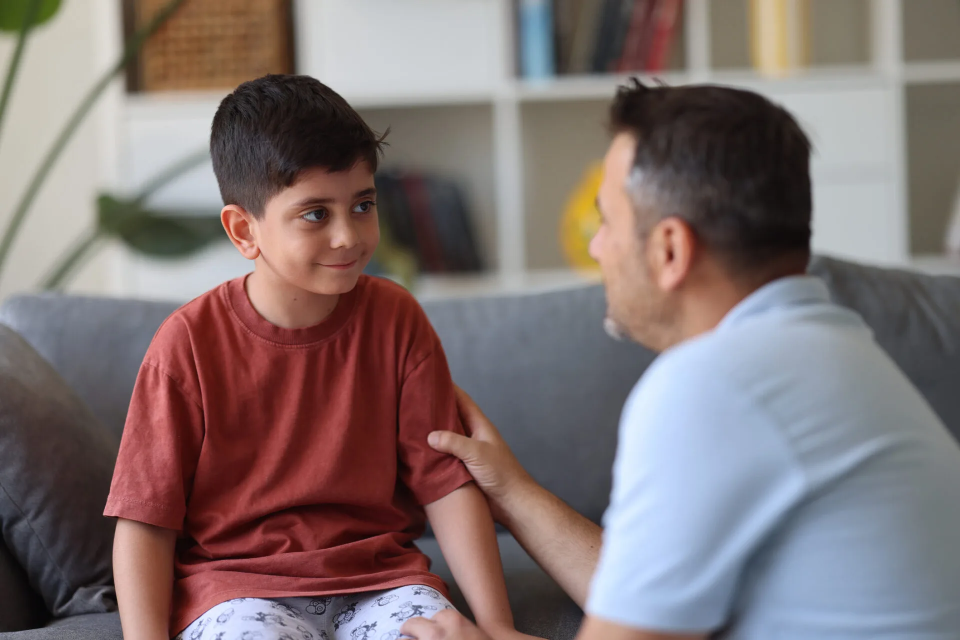 Father and child talking while child smiles